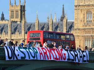 A banner on Westminster Bridge reads "UK: Stop Arming Israel"